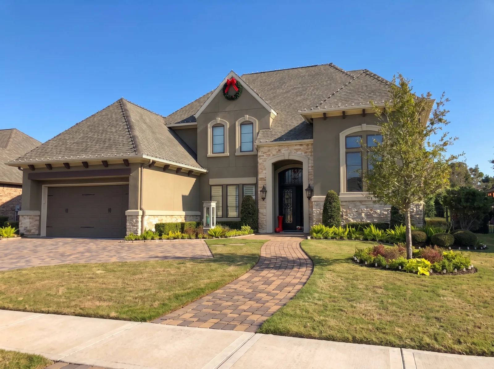 A Houston home at midday with Christmas lights installed along the rooflines but switched off